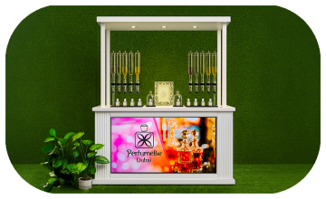 Perfume Booth setup in Dubai featuring a branded fragrance bar with colorful dispensers, interactive screen, and artificial grass backdrop for events and exhibitions
